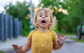 Cheerful child on the street portrait. Selective focus. Kid.