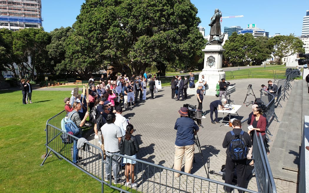 Migrant family protest outside Parliament in June 2021