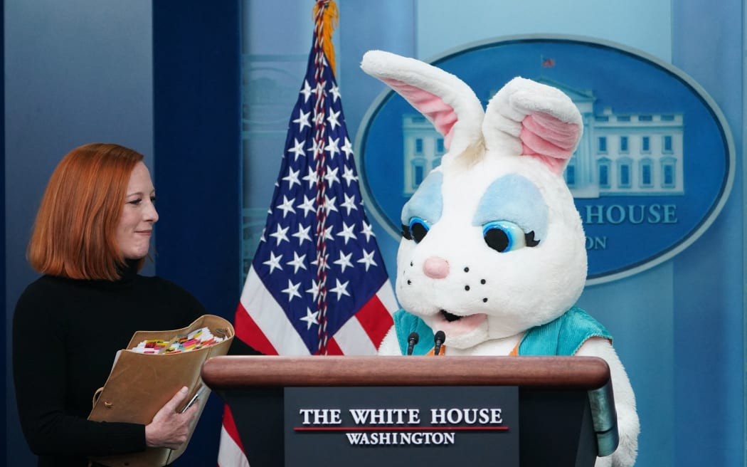 White House Press Secretary Jen Psaki and an Easter Bunny arrive for the daily briefing in the Brady Briefing Room of the White House in Washington, DC on  April 18, 2022. (Photo by MANDEL NGAN / AFP)