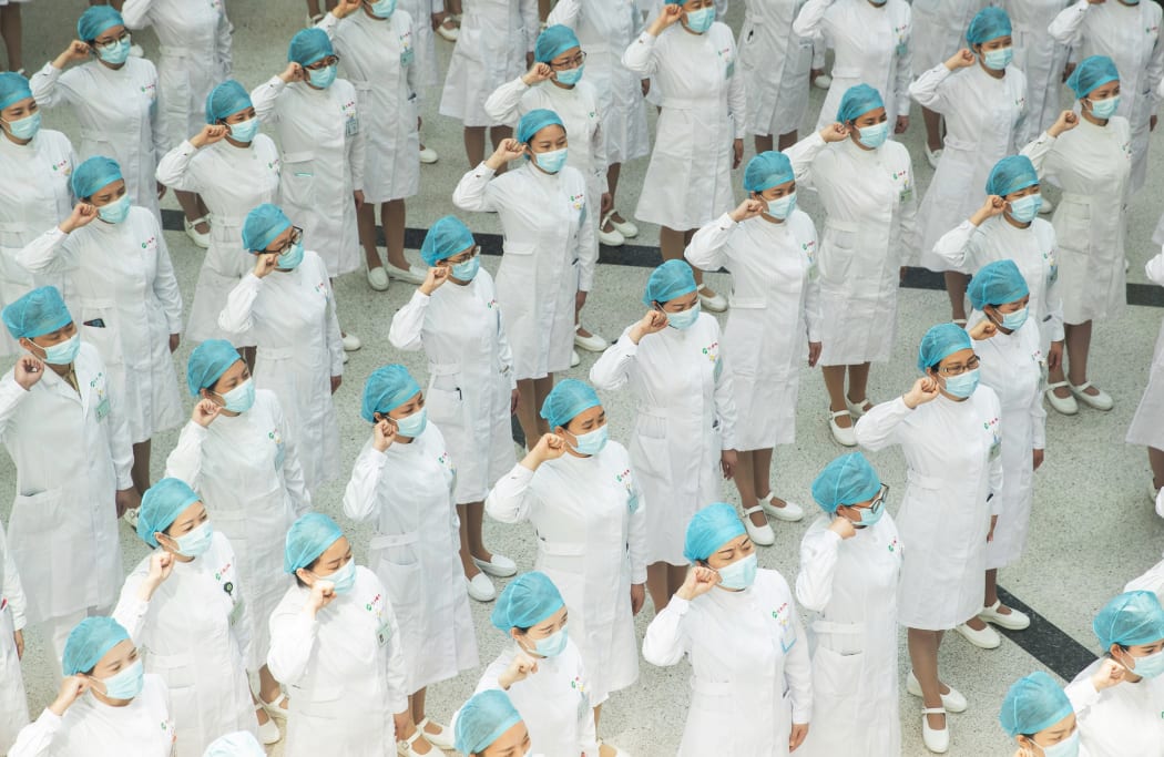 Nurses recite an oath during a ceremony marking International Nurses Day, at Tongji Hospital in Wuhan, in China's central Hubei province on May 12, 2020.