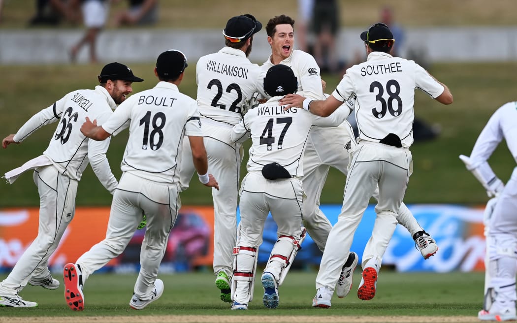 New Zealand bowler Mitchell Santner surrounded by test team-mates.
