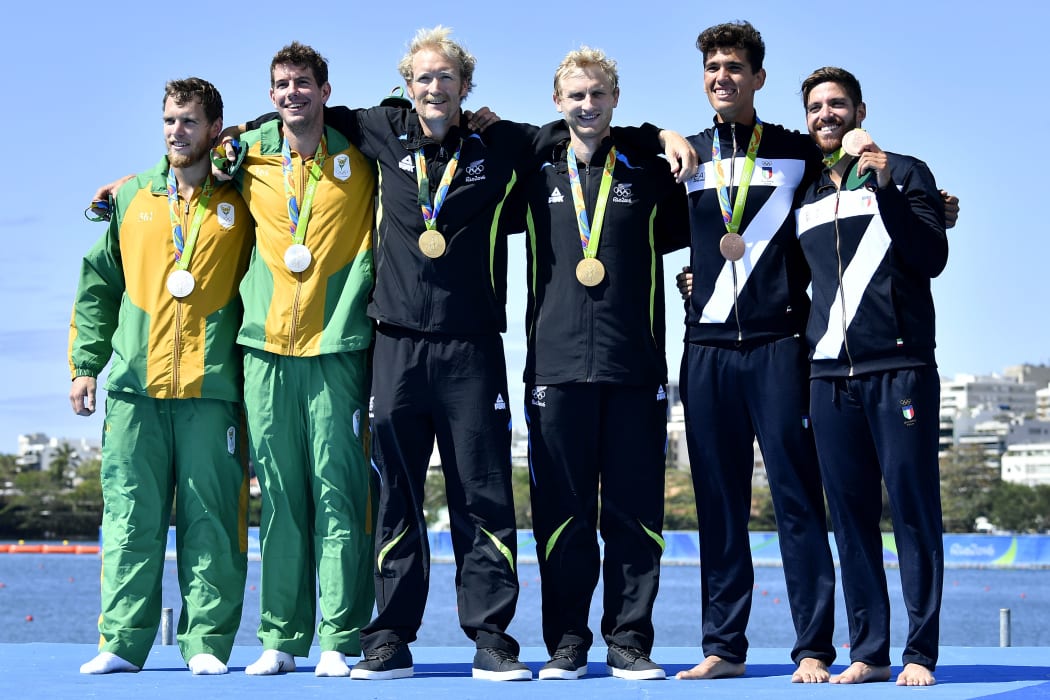 South Africa's Shaun Keeling and South Africa's Lawrence Brittain, New Zealand's Eric Murray, New Zealand's Hamish Bond, Italy's Marco di Costanzo and Italy's Giovanni Abagnale celebrate with their medals on the podium in Rio.