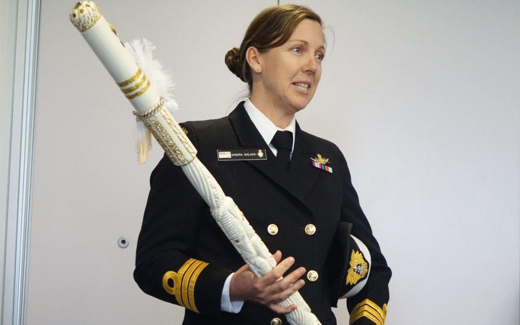 Commander Sandra Walker with the carved pou - the new symbol of command for the HMSNZ Endeavour.