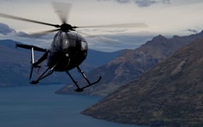 A helicopter circling over Queenstown, New Zealand.