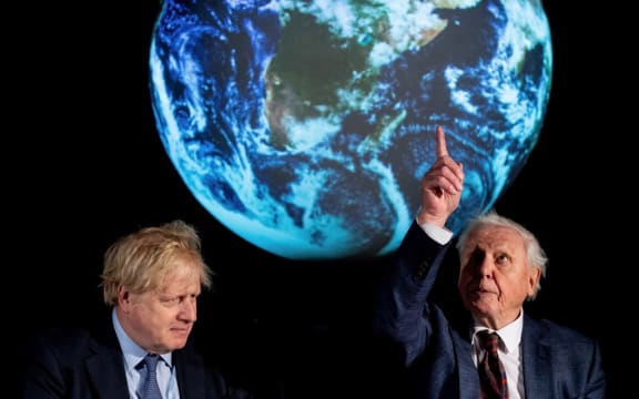 Britain's Prime Minister Boris Johnson (L) sits with British broadcaster and conservationist David Attenborough, during an event to launch the United Nations' Climate Change conference, COP26, in central London on February 4, 2020