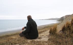 East Coast Protection Group member Rob Peter looks over the east coast, towards the Cape Cambell Lighthouse.