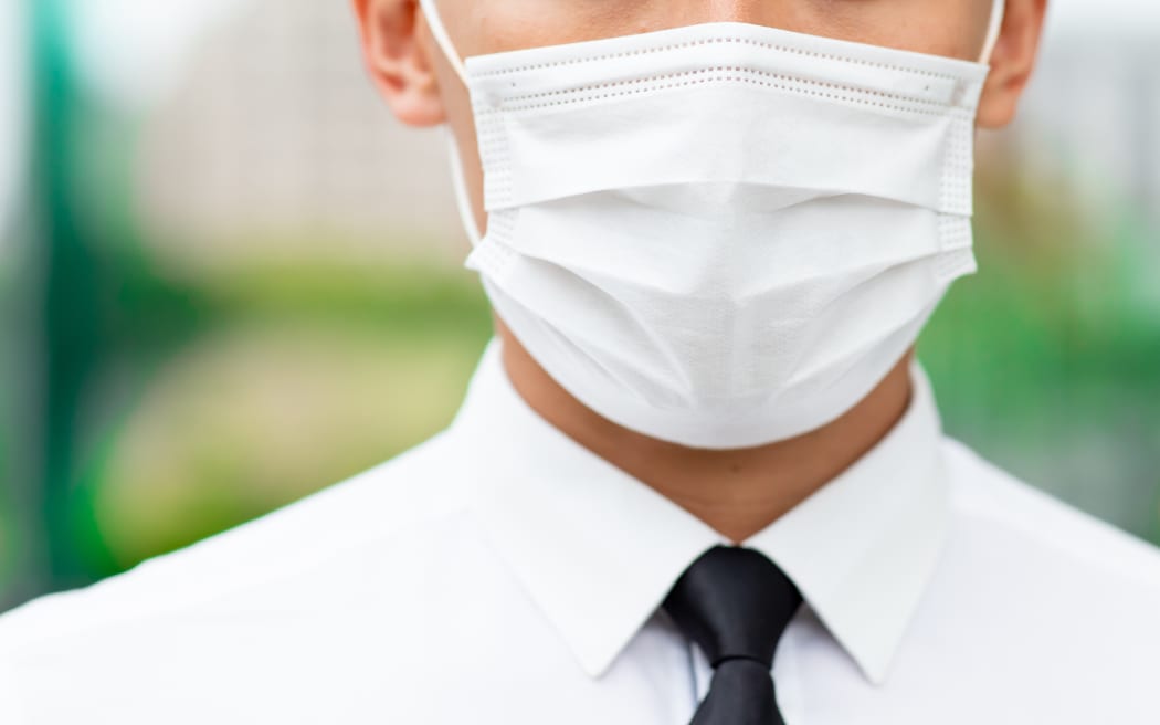 Close up of man wear surgical mask face protection in the city.