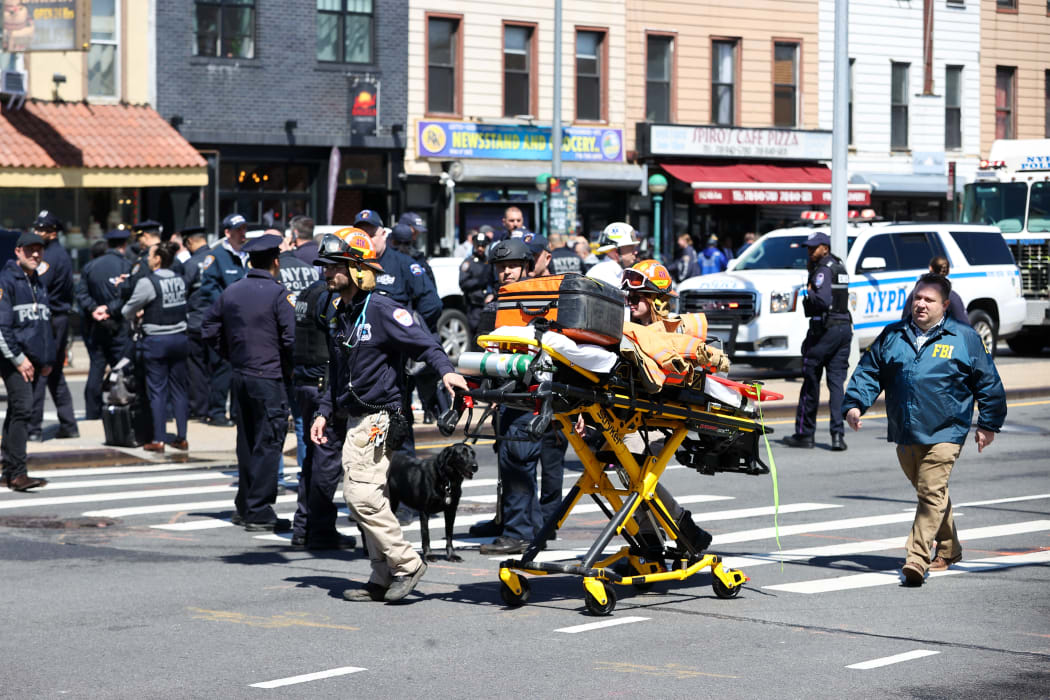 New York City Police Department members investigate the crime scene after multiple people were shot and undetonated devices were found at a subway station in New York City.