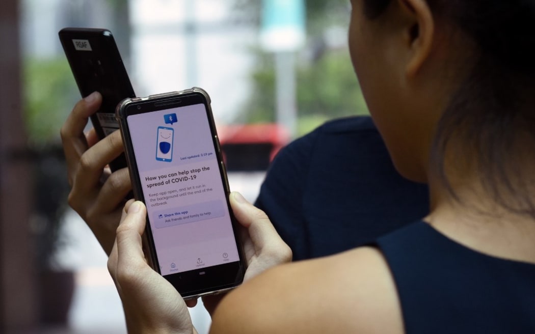 Government Technology Agency (GovTech) staff demonstrate Singapore's new contact-tracing smarthphone app called TraceTogether, as a preventive measure against the COVID-19 coronavirus in Singapore .