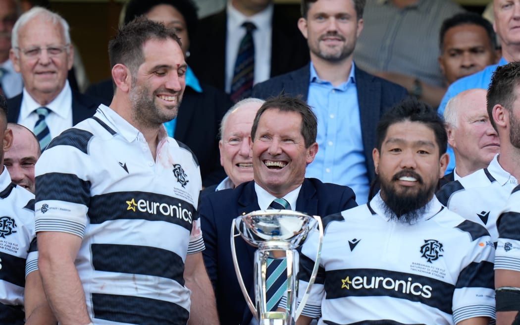 Sam Whitelock of and Shota Horie of the Barbarians together with Robbie Deans head coach of the Barbarians, 2024.
