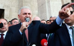 Turkish Prime Minister Binali Yildirim (C) speaks to the public after a meeting with the Turkish Speaker of Parliament in Ankara.