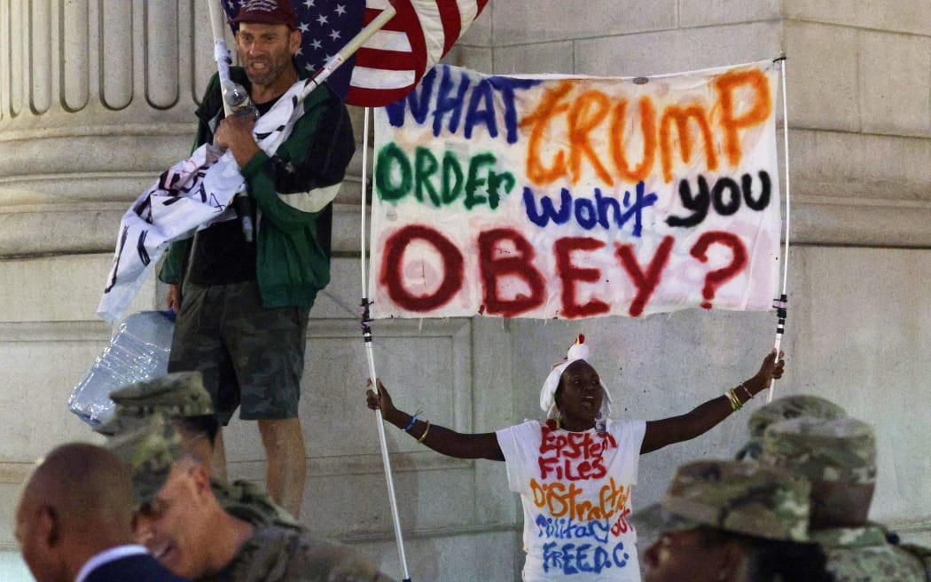 Protesters yell at members of the National Guard outside Union Station on August 19, 2025 in Washington, DC. An increased presence of law enforcement has been seen throughout the nation's capital since US President Donald Trump announced plans to deploy federal officers and the US National Guard.   Alex Wong/Getty Images/AFP (Photo by ALEX WONG / GETTY IMAGES NORTH AMERICA / Getty Images via AFP)