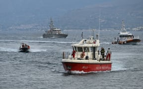 Boats return to Porticello harbour near Palermo, Sicily, bringing bodies ashore on 21 August, 2024, two days after the British-flagged luxury yacht Bayesian sank.