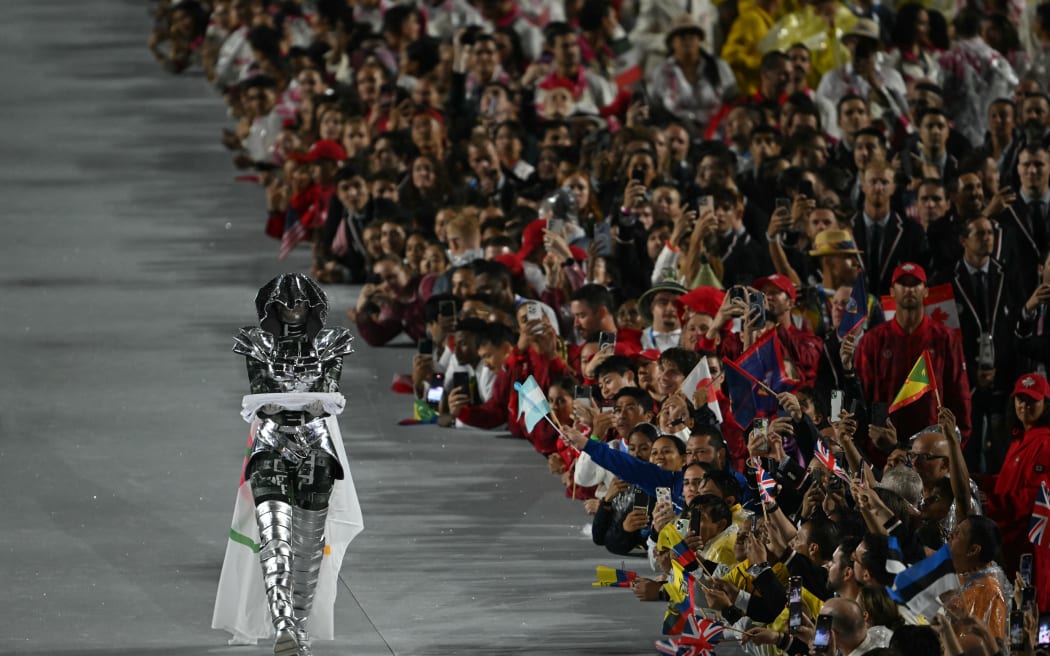 The horsewoman walks with the Olympic flag past athletes at the Trocadero during the opening ceremony of the Paris 2024 Olympic Games in Paris on July 26, 2024. (Photo by Fabrice COFFRINI / AFP)