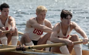 (l-r.) Bruce Herbelin-Earle stars as Shorty Hunt, Callum Turner as Joe Rantz and Jack Mulhern as Don Hume in director George Clooney’s THE BOYS IN THE BOAT. An Amazon MGM Studios film. Photo credit: Laurie Sparham. © 2023 Metro-Goldwyn-Mayer Pictures Inc. All Rights Reserved.