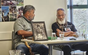Ōpihi Whanaungakore trustees Hemi Hireme and Rapata Kopae with a photo of Guide Kate, famous for rescuing several people during the Tarawera eruption, who was buried at the urupa after having lived to 100 years of age.