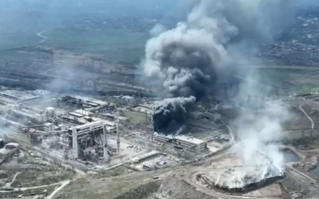 A video grab taken from a footage released by Mariupol City Council on 19 April 2022 shows clouds of smoke billowing above Azovstal steel plant and the destroyed gates of Azov Shipyard, as Russia continues its push to capture the besieged port city of Mariupol.
