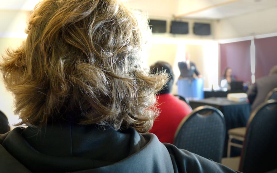 Eileen Cameron watches on as her house goes under auction in Manukau, Auckland.
