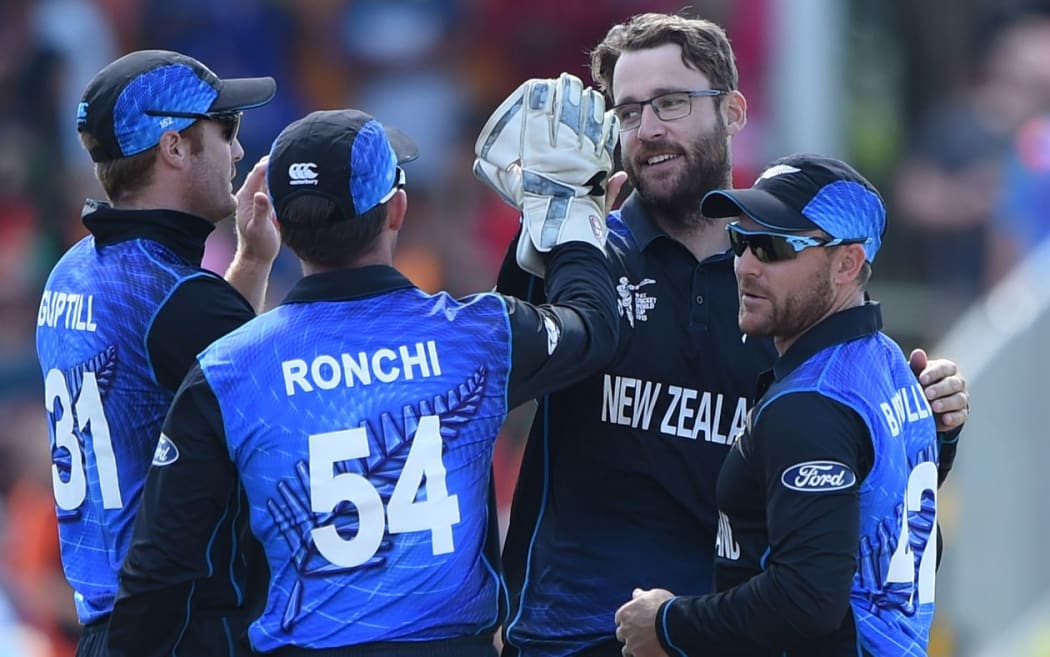 Daniel Vettori celebrates the wicket of Nawroz Mangal with team mates.