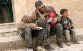 Residents of the northern Syrian city of Aleppo after an air strike.