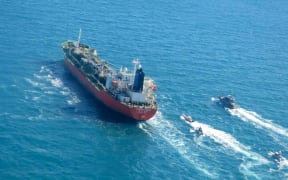 A picture obtained by AFP from the Iranian news agency Tasnim on 4 January 2021, shows the South Korean-flagged tanker being escorted by Iran's Revolutionary Guards navy after being seized in the Gulf.