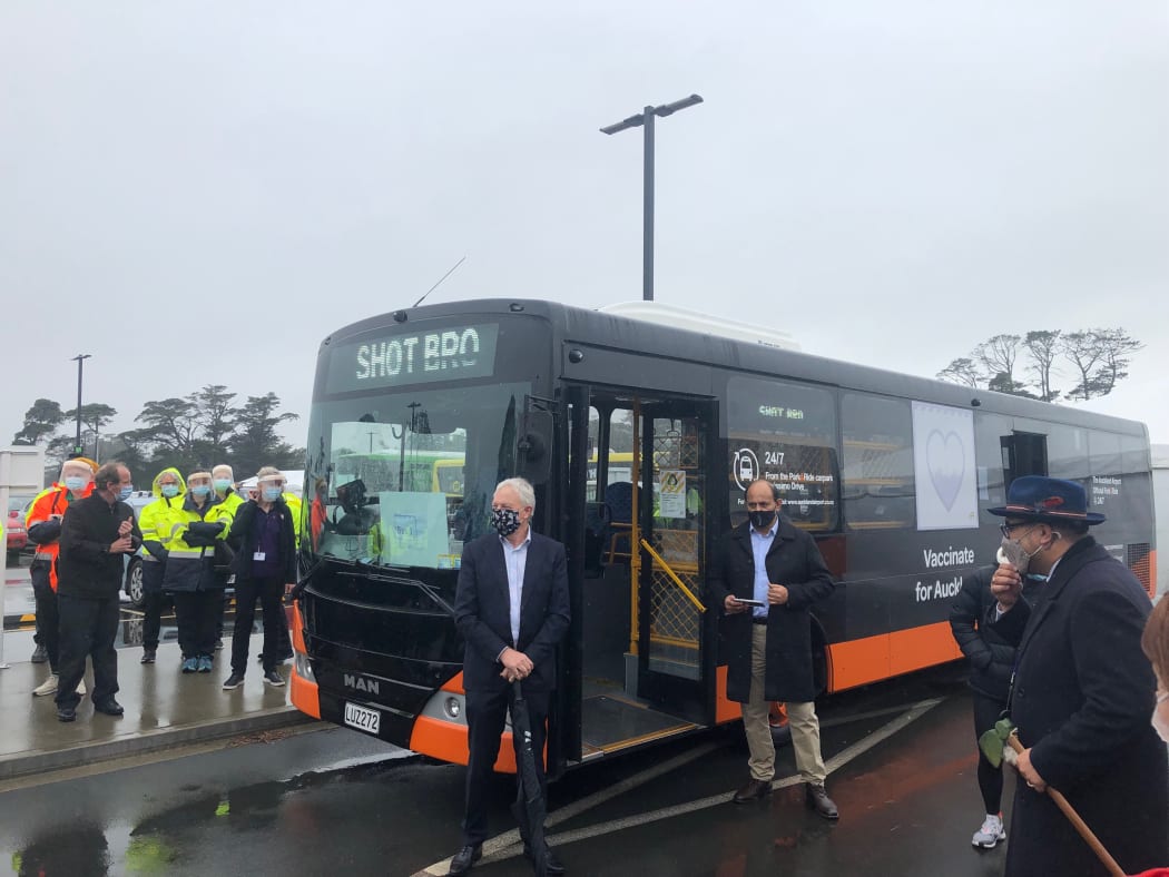 Auckland Mayor Phil Goff stands in front of one of the first vaccination buses