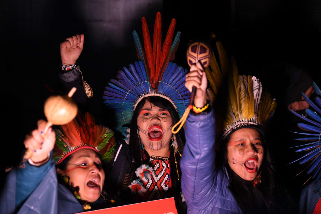 Indigenous people chant as they participate in a protest rally during a global day of action on climate change in Glasgow.