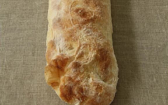 A loaf of ciabatta bread on a hessian cloth