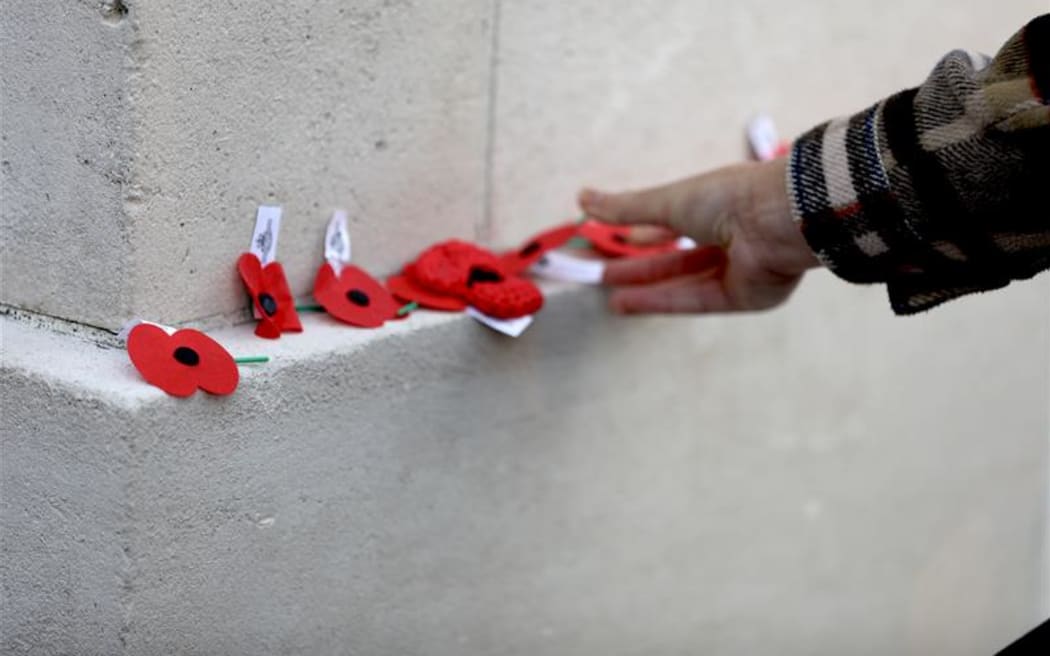 People laying poppies at Auckland War Memorial Museum on Anzac Day 25 April 2025.
