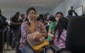 Family members of passengers of missing flight QZ8501 gather at Juanda international airport in Surabaya in East Java.