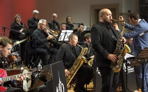 The Auckland Jazz Orchestra play on stage of the Concert Chamber of the Auckland Town Hall.