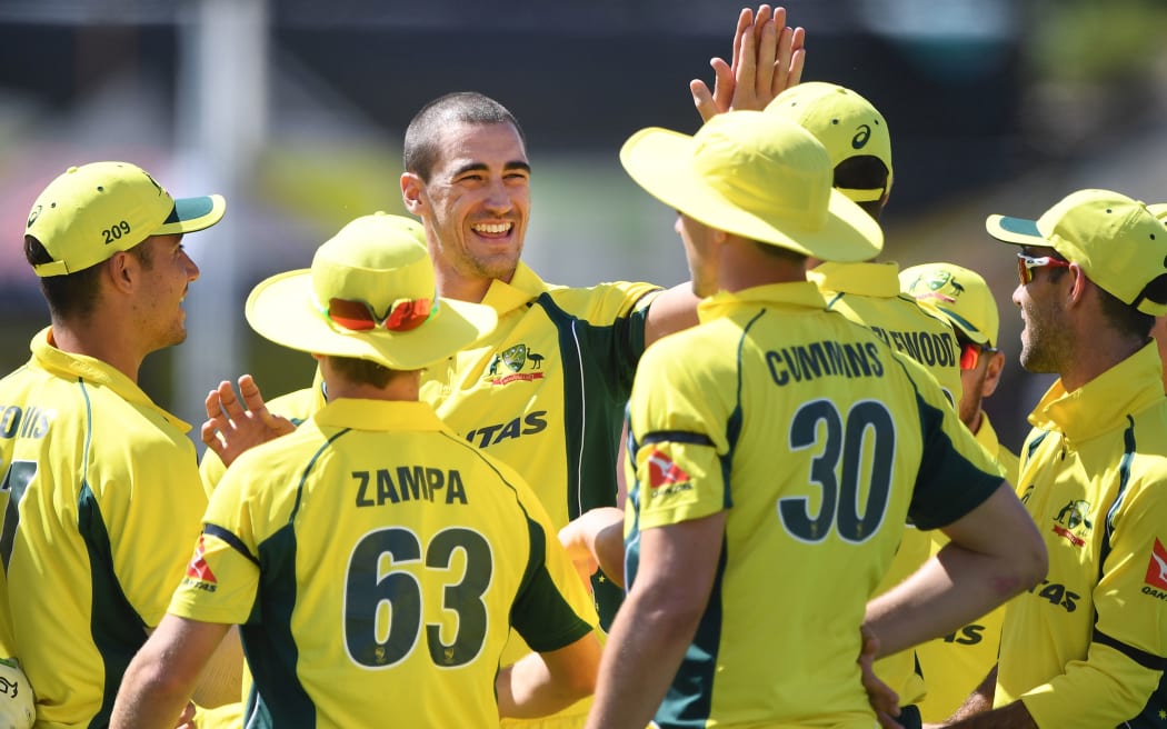 Mitchell Starc and team mates celebrate the wicket of Latham.