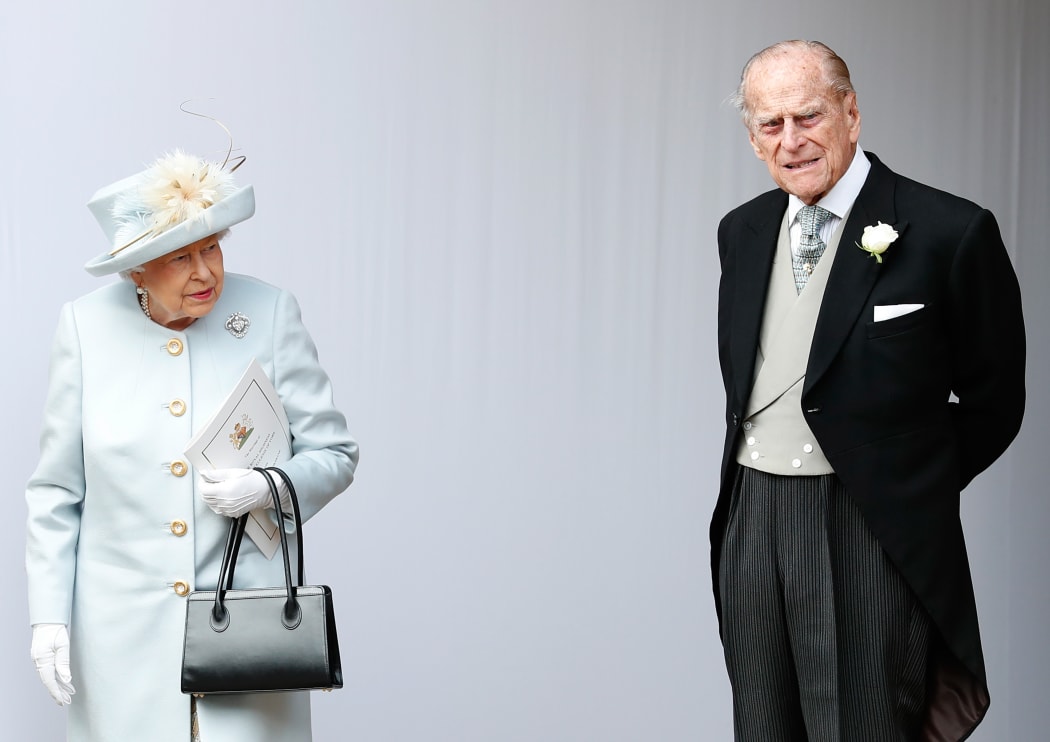 Queen Elizabeth II and Britain's Prince Philip, Duke of Edinburgh wait for the carriage carrying Princess Eugenie of York and her husband Jack Brooksbank to pass at the start of the procession after their wedding ceremony at St George's Chapel, Windsor Castle.