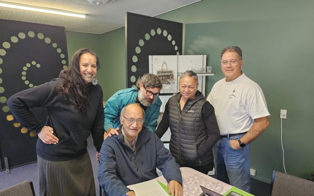 Turiroa chairman Daren King (seated) signing the Turiroa agreement, with directors (from left) Benita Tahuri, Irah Heyder, Tina Wilcox and Dean Whaanga