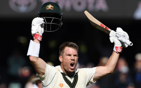 Australia's batsman David Warner celebrates reaching his triple century (300 runs) during the day two of the second cricket Test match between Australia and Pakistan in Adelaide on November 30, 2019.