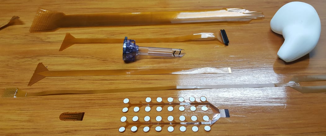 The Fleximap team is continually refining the flexible electrodes. The white bulbous piece of plastic is a life-sized model of the human stomach.