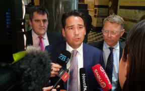 National leader Simon Bridges, flanked by National's Transport spokesperson Chris Bishop (L) and Finance and Infrastructure spokesperson Paul Goldsmith (R)