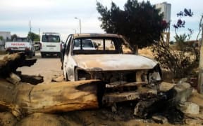 A damaged car at the site of the Egypt Sinai mosque bombing.