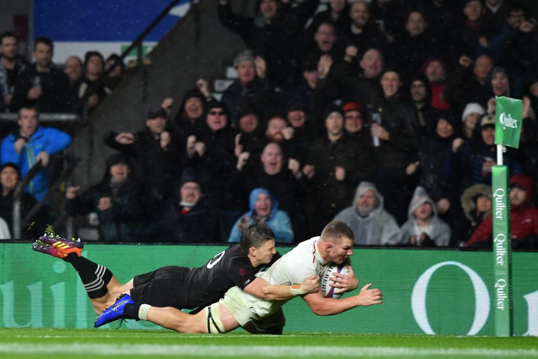 England's flanker Sam Underhill dives over the line as he's tackled by New Zealand's fly-half Beauden Barrett. The try was disallowed.
