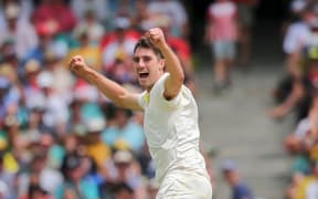 Pat Cummins celebrates taking the wicket.