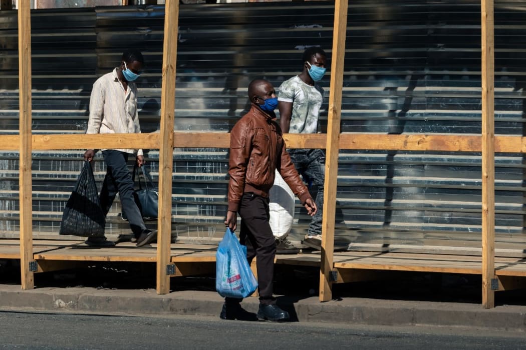 A few remaining pedestrians walk in Harare as many people left the central business district on June 2.