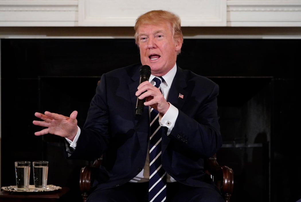 US President Donald Trump takes part in a listening session on gun violence with teachers and students in the State Dining Room of the White House.