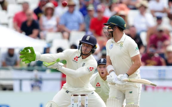 Joss Buttler and Ben Stokes of England look on as Dean Elgar of South Africa edges the ball into the air.