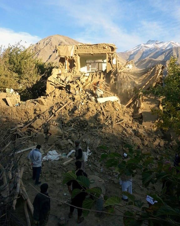 Afghan residents examine a damaged house in Raman Kheel in the Panjshir Valley after the deadly 7.5 magnitude earthquake on 26 October 2015.