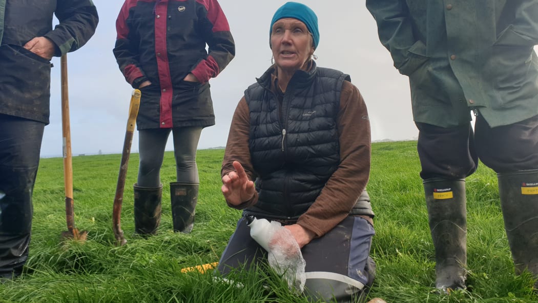 Integrity Soils coach Jules Matthews talks workshop participants through a water infiltration test.