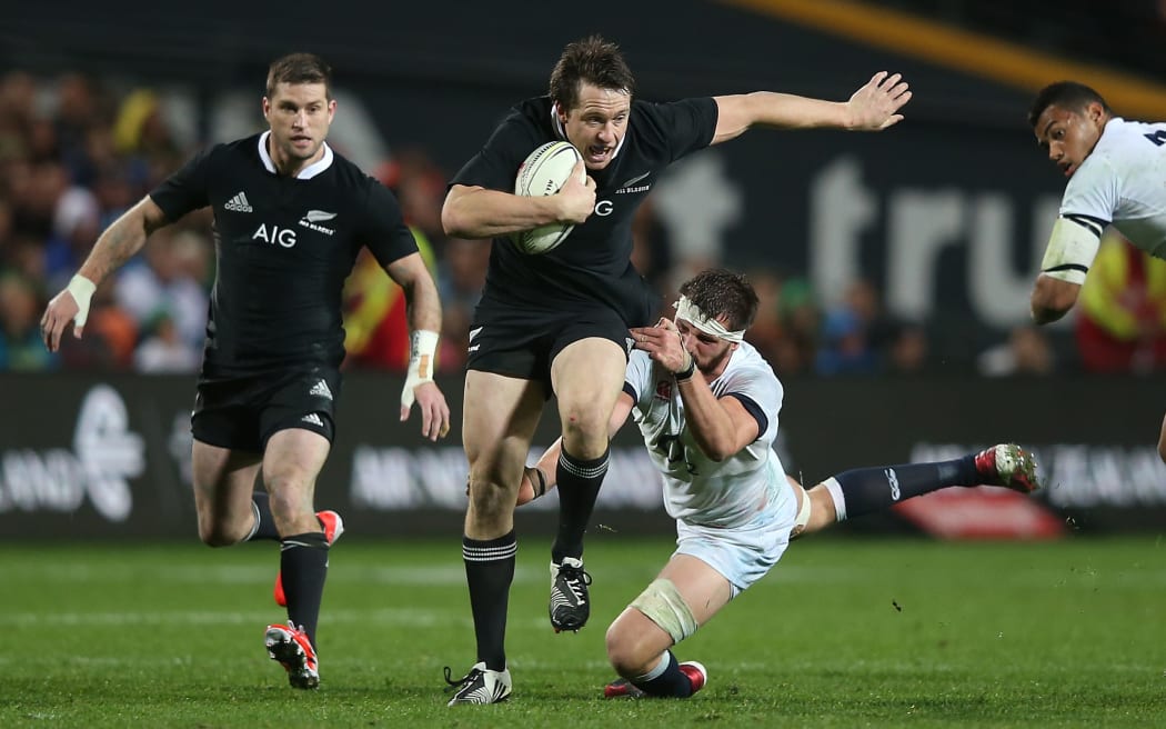 Ben Smith of the All Blacks breaks the tackle of Tom Wood of England during the third rugby test between the All Blacks and England in Hamilton. 2014.