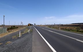 A British backpacker was pulled over on Queensland's Warrego Highway, with her alleged attacker hiding in a small alcove of the car.