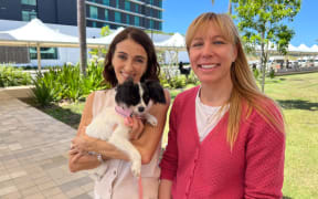 Julija Kinghorn (right) travelled on the inaugural flight with Poppy the six-month-old Papillon.