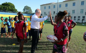 Australia's Prime Minister Scott Morrison plays rugby with school children in Honiara.