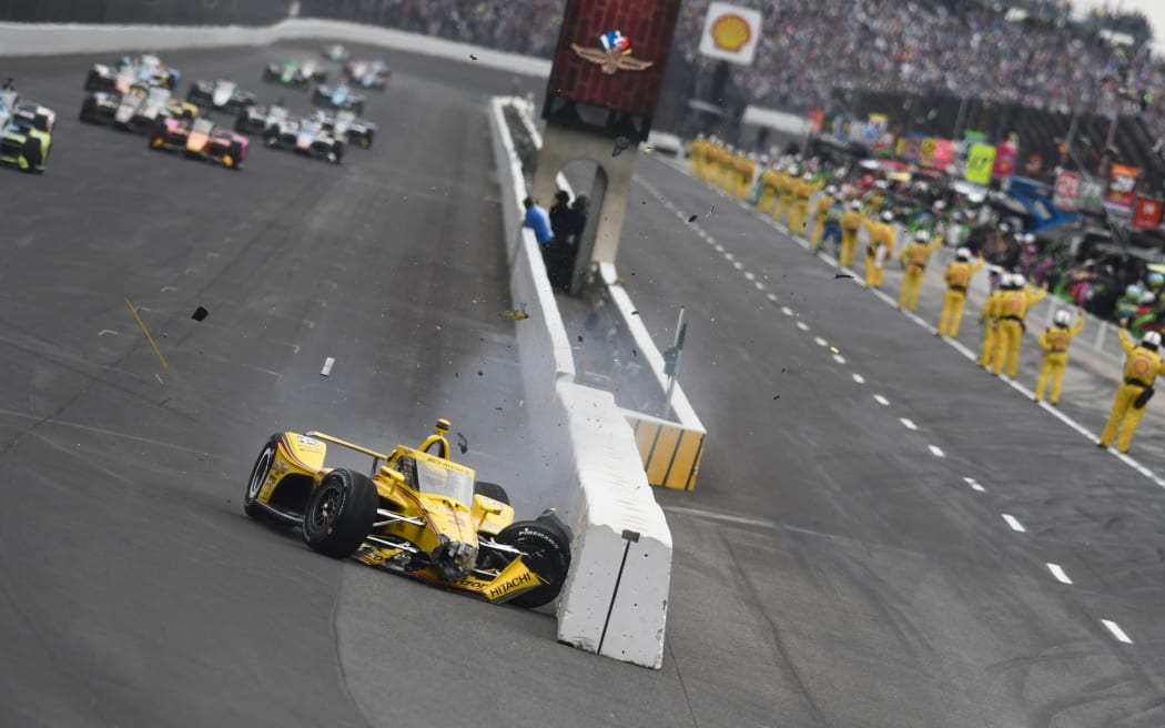 New Zealand driver Scott McLaughlin slides along pit wall before the start of the 2025 Indianapolis 500.